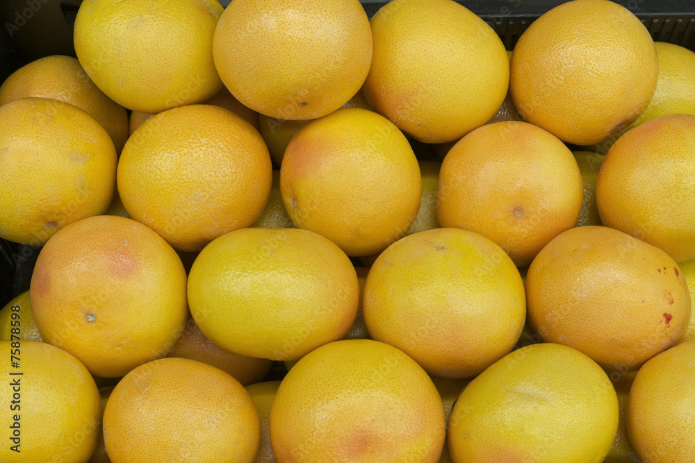 backdrop of ripe grapefruit at vegetable market