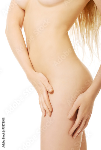 Woman touching her naked thigh
