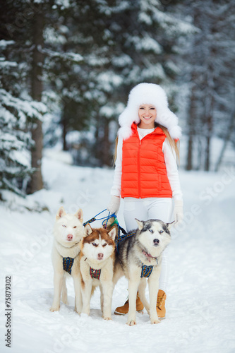 Portrait of a beautiful woman with Siberian huskies - Husky.
