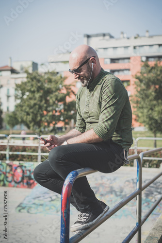 handsome middle aged man listening to music