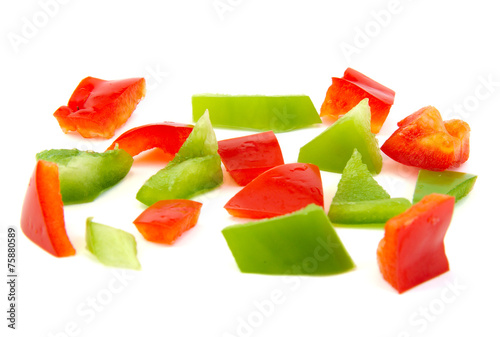Chopped red and green pepper on white background.