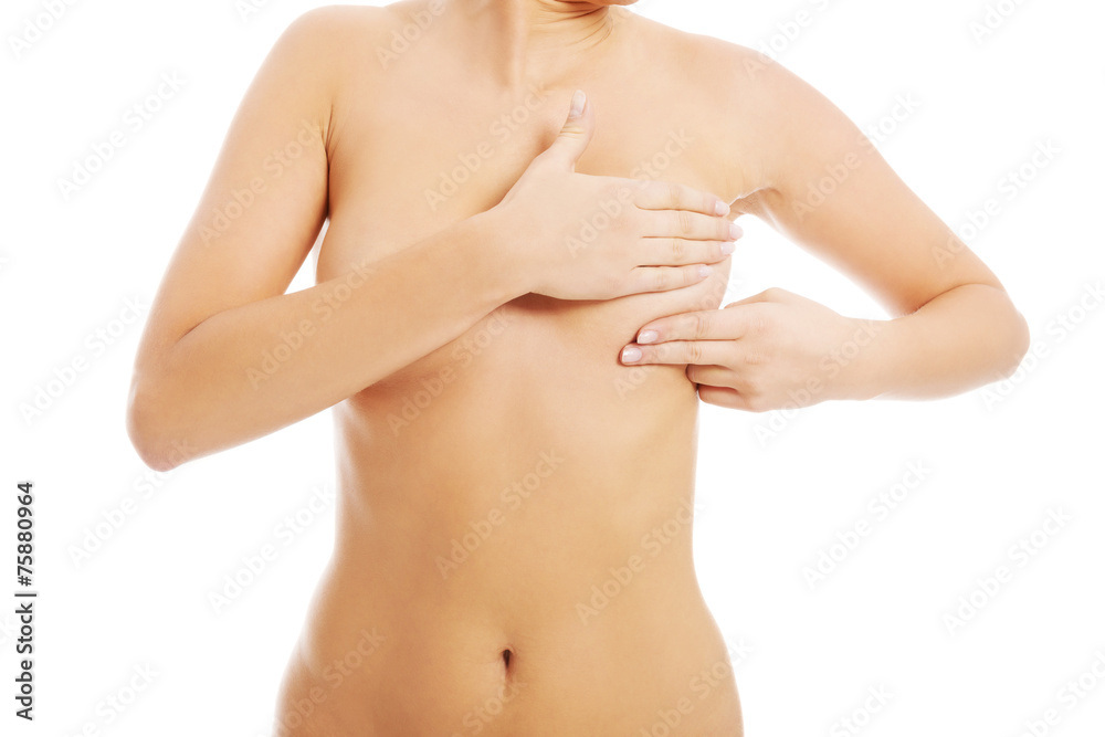 Young topless woman is doing breast self examination. Young topless woman is doing breast self examination.