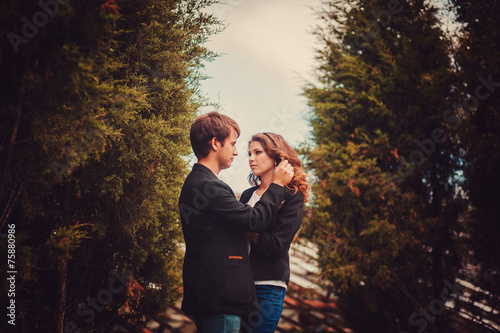 Sensual outdoor portrait of young fashion couple posing