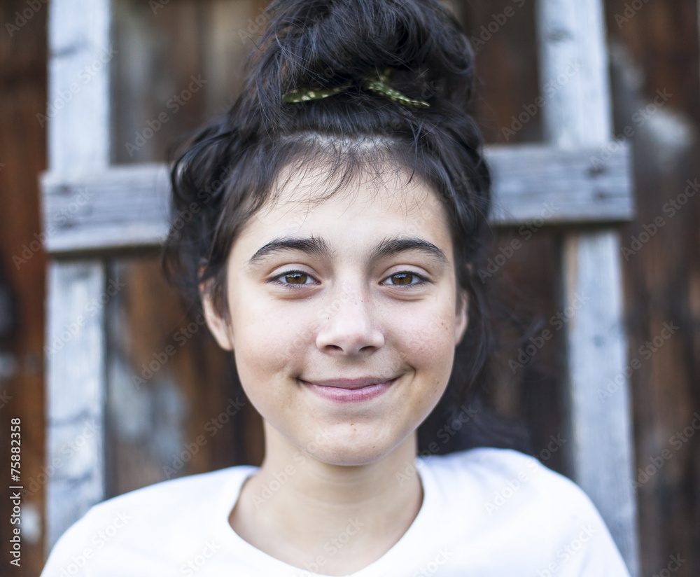 Portrait of a positive teen girl with black hair, outdoors. Portrait of a positive teen girl with black hair, outdoors.