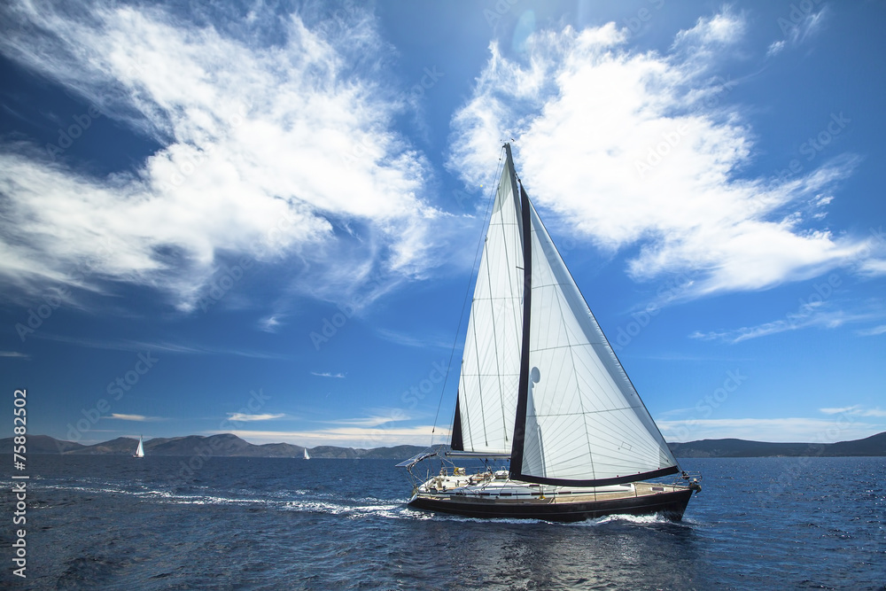Sailboat participate in sailing regatta. Luxury Yachts.