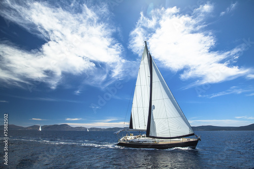 Sailboat participate in sailing regatta. Luxury Yachts.