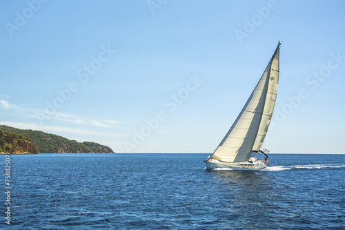 Sailing ship yachts with white sails. Cruise sailing.