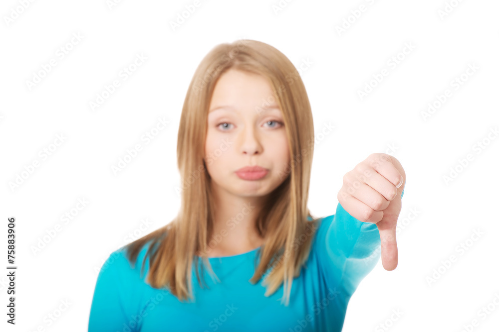 Dissatisfied female student showing thumbs down Dissatisfied female student showing thumbs down