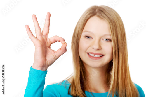 Young woman showing perfect sign