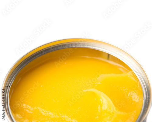 Indian ghee in a tin can over white background