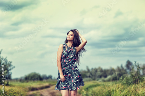beautiful brunette in a field on a sunny day