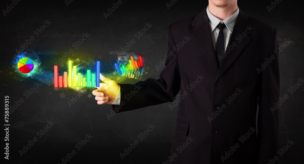 Handsome young business man touching colorful modern graph syste Handsome young business man touching colorful modern graph syste