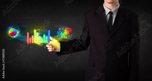 Fototapeta Naklejka Na Ścianę i Meble -  Handsome young business man touching colorful modern graph syste