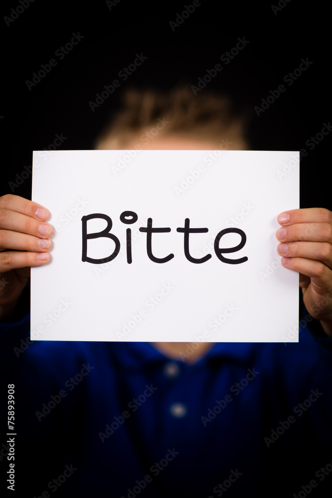 Child holding sign with German word Bitte - Please Child holding sign with German word Bitte - Please