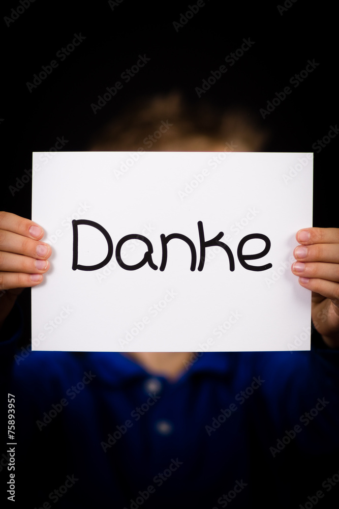 Child holding sign with German word Danke - Thank You Child holding sign with German word Danke - Thank You