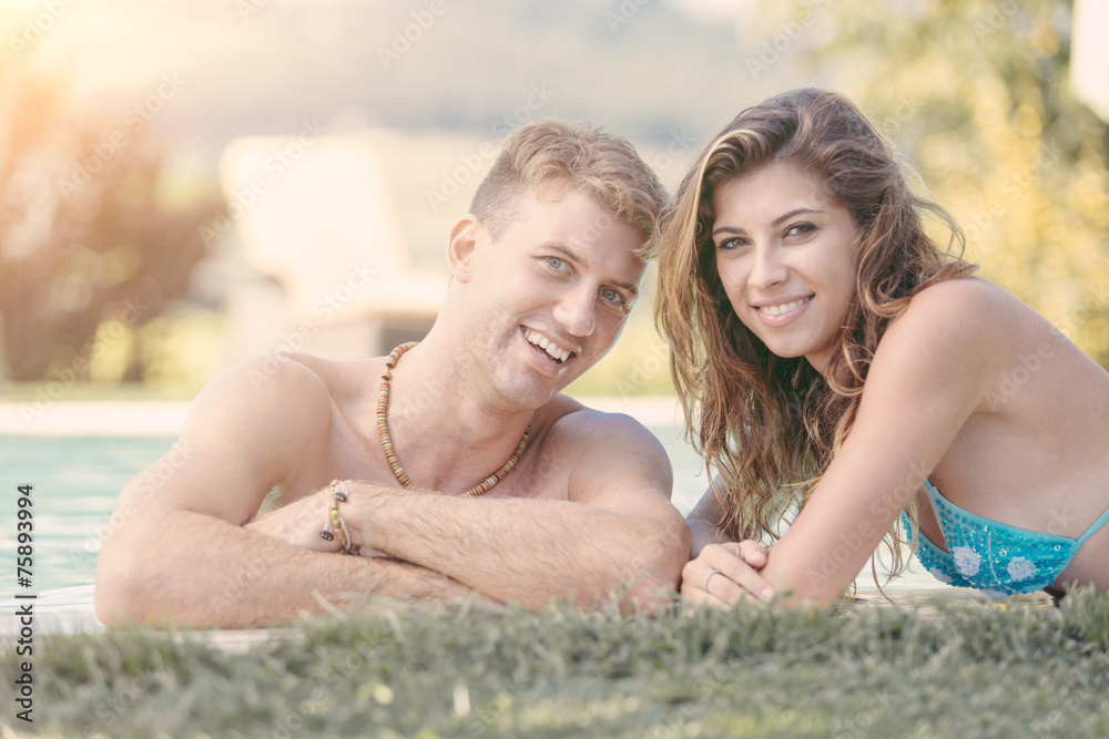 Fototapeta premium Beautiful Young Couple Next to Swimming Pool