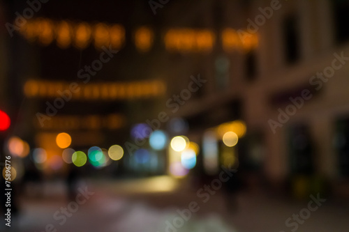 people moving on old city winter night street blurred © Pellinni