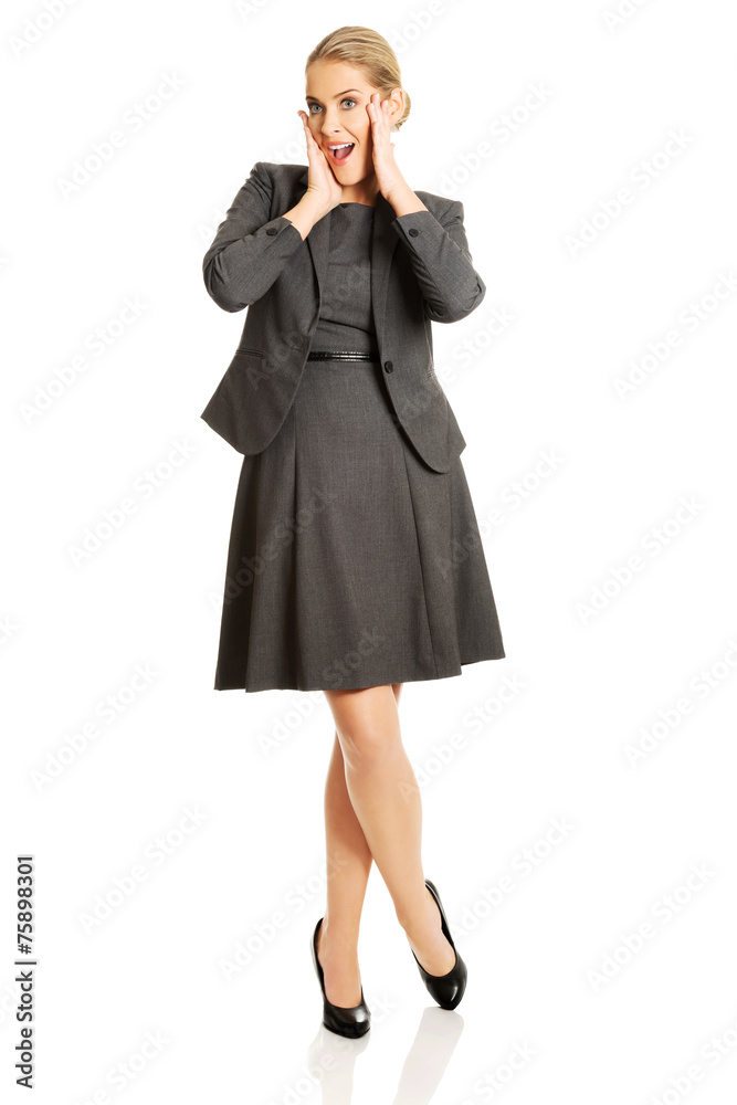 Amazed businesswoman holding hands on chin Amazed businesswoman holding hands on chin