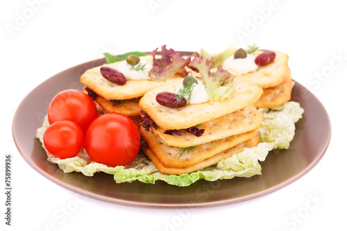 Crackers with fresh vegetables and cream