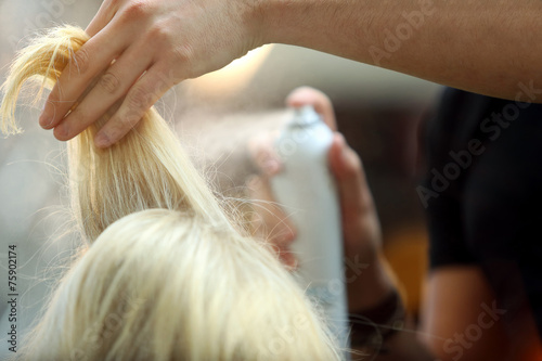 Hairdresser sprayed blond hair