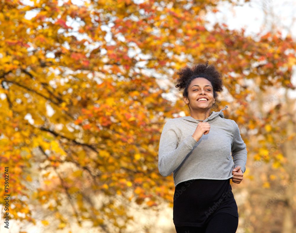 Happy young woman running outdoors in the park Happy young woman running outdoors in the park