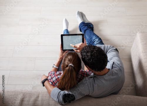 Young couple using tablet.Relaxing.