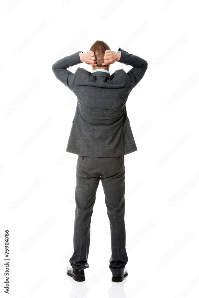 Full length businessman putting hands on the nape Full length businessman putting hands on the nape