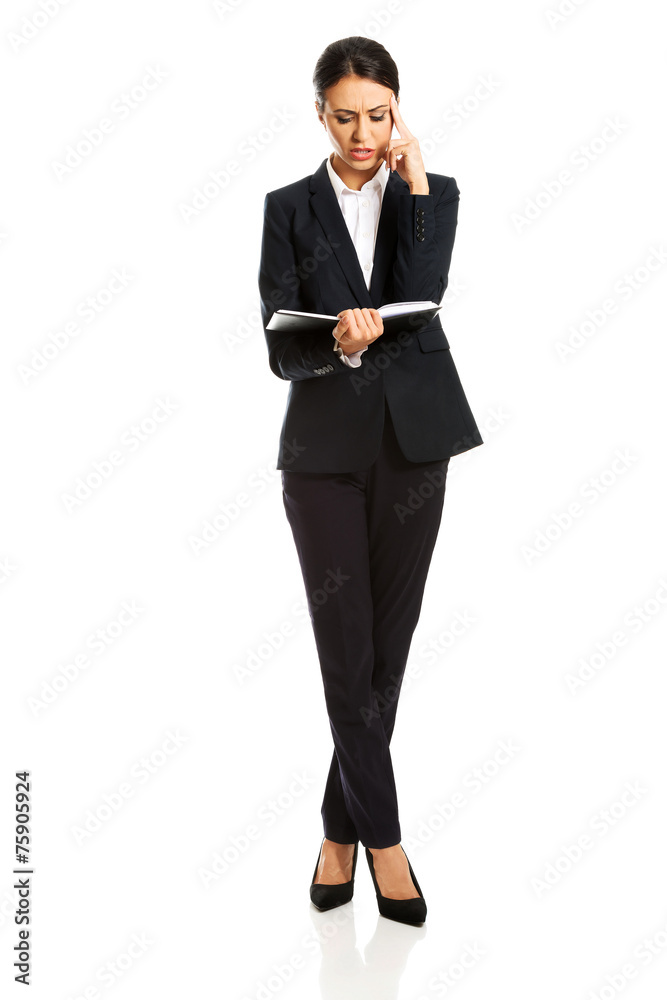 Businesswoman reading her notes Businesswoman reading her notes