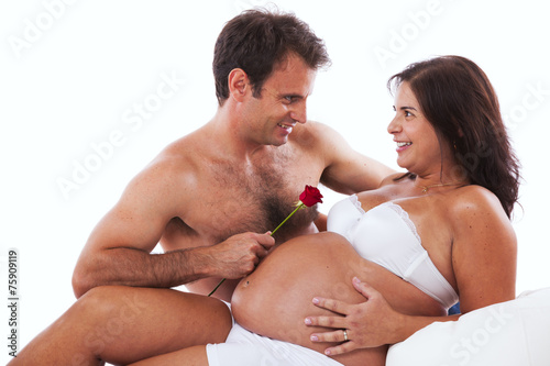 Husband embrassing his pregnant wife photo