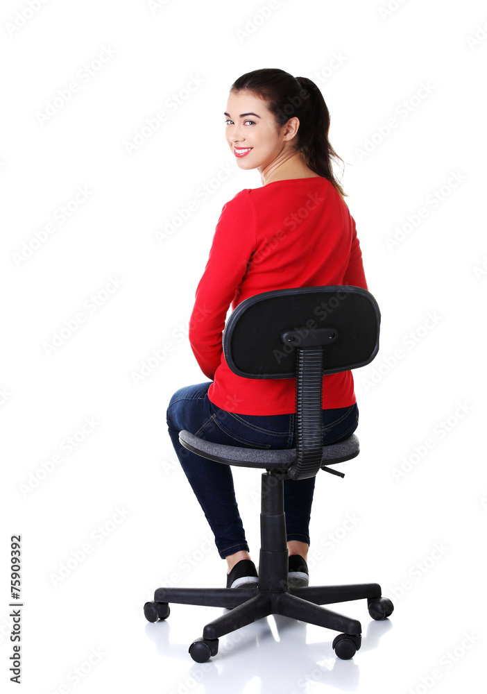 Back view student woman siting on armchair Back view student woman siting on armchair