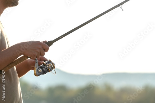 Modern clean fishing rod in hands