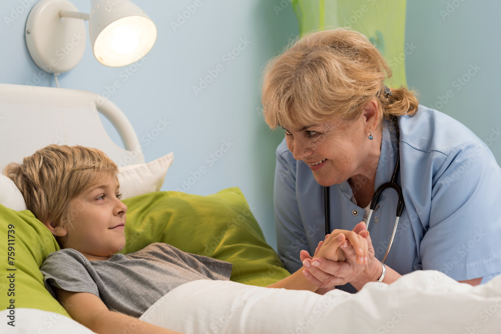 Pediatrician holding hand of her patient Pediatrician holding hand of her patient
