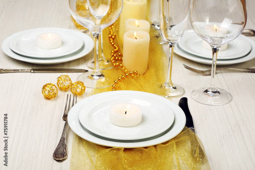 Beautiful holiday table setting in white and gold color Beautiful holiday table setting in white and gold color