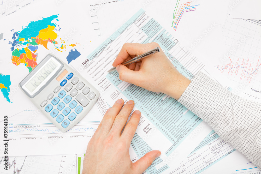 Business man with calculator and financial charts and graphs Business man with calculator and financial charts and graphs