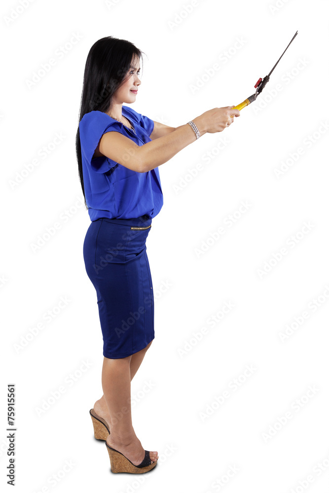 Woman holding a scissors to cut something Woman holding a scissors to cut something