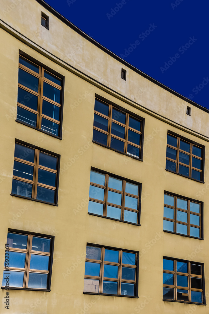 Blue windows on a yellow facade.