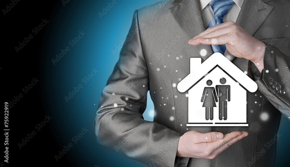 businessman protecting family in home with hands businessman protecting family in home with hands