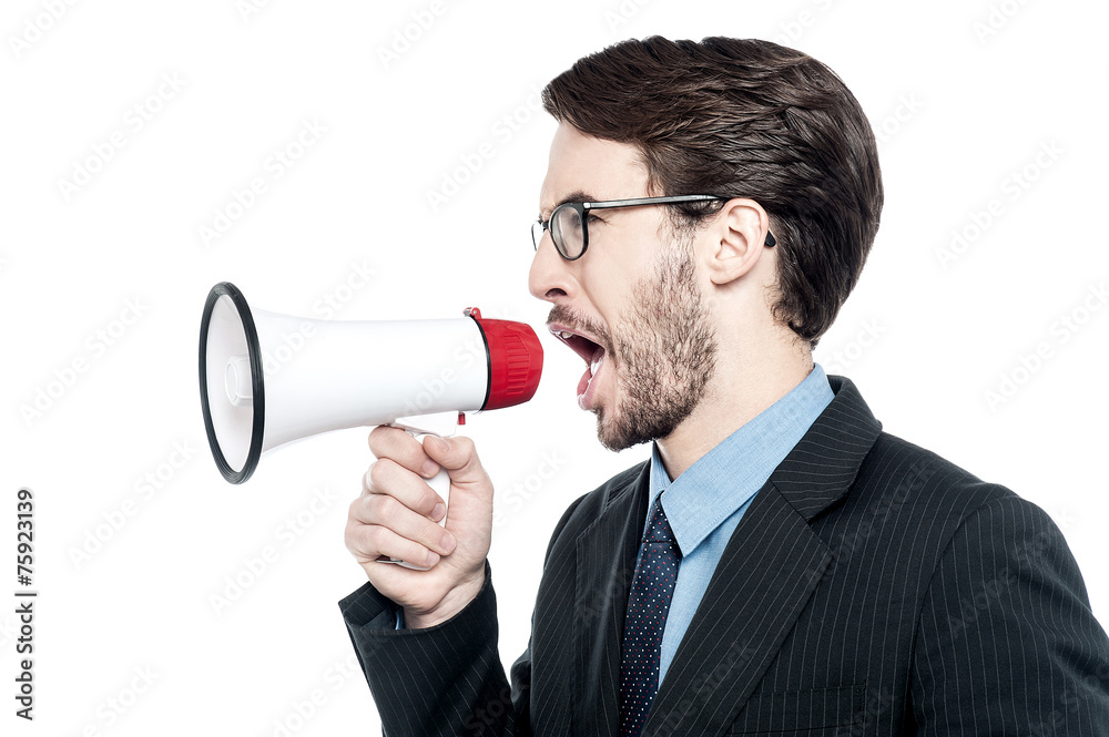 Man screaming with anger over loudhailer Man screaming with anger over loudhailer