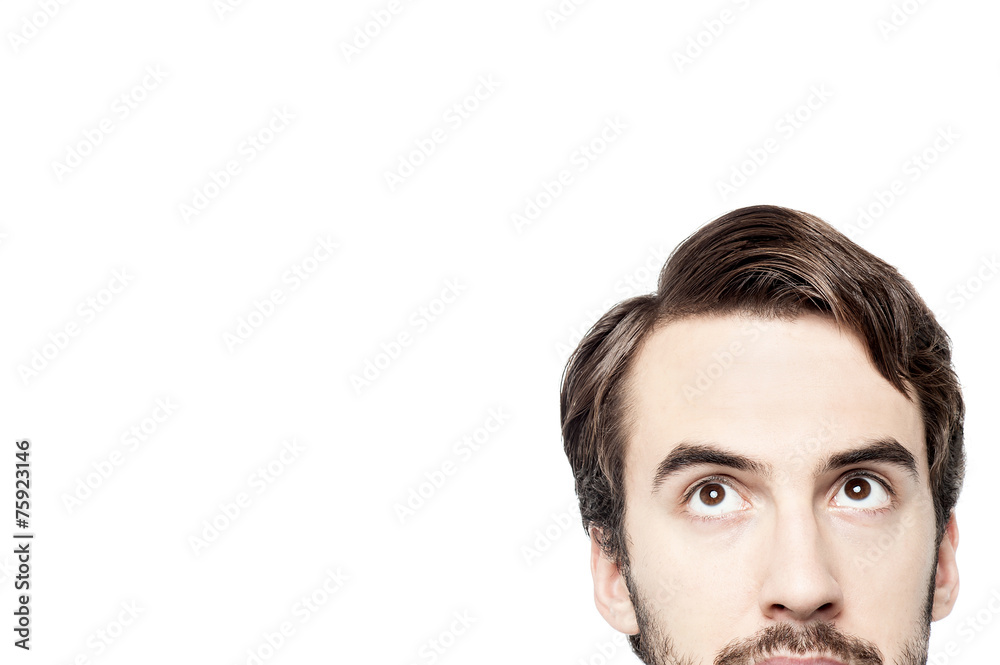 Cropped image of young man looking up Cropped image of young man looking up