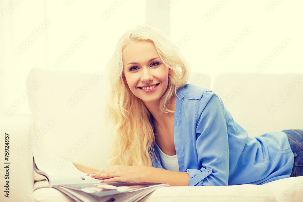 woman lying on couch and reading magazine at home woman lying on couch and reading magazine at home