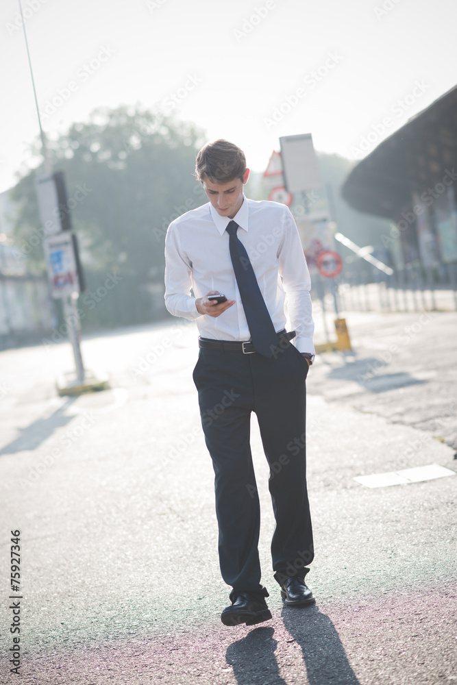 young handsome elegant blonde model man using smart phone young handsome elegant blonde model man using smart phone
