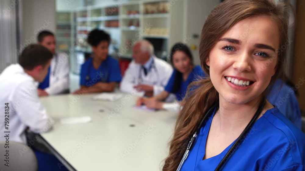 Medical student smiling at the camera during class Medical student smiling at the camera during class