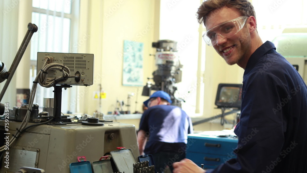Young mechanic smiling at camera Young mechanic smiling at camera