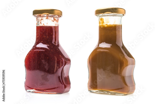 Caramel sauce and strawberry jam bottles