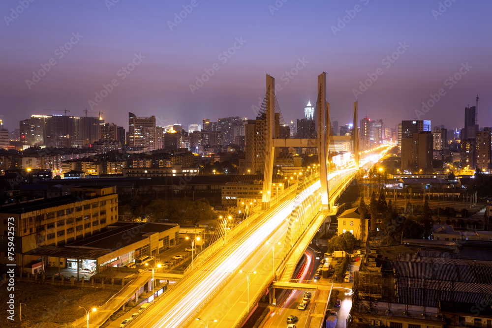 Traffic through city bridge at night in hangzhou,china