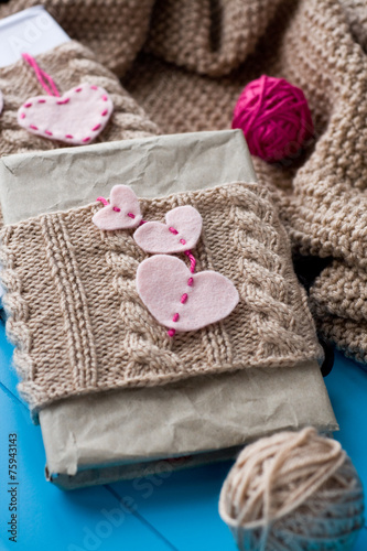 Two old pads in knitted cover with felt hearts