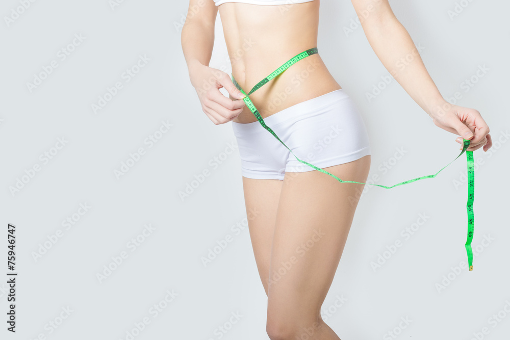 sports beautiful slim woman measuring perfect shape nice hips
