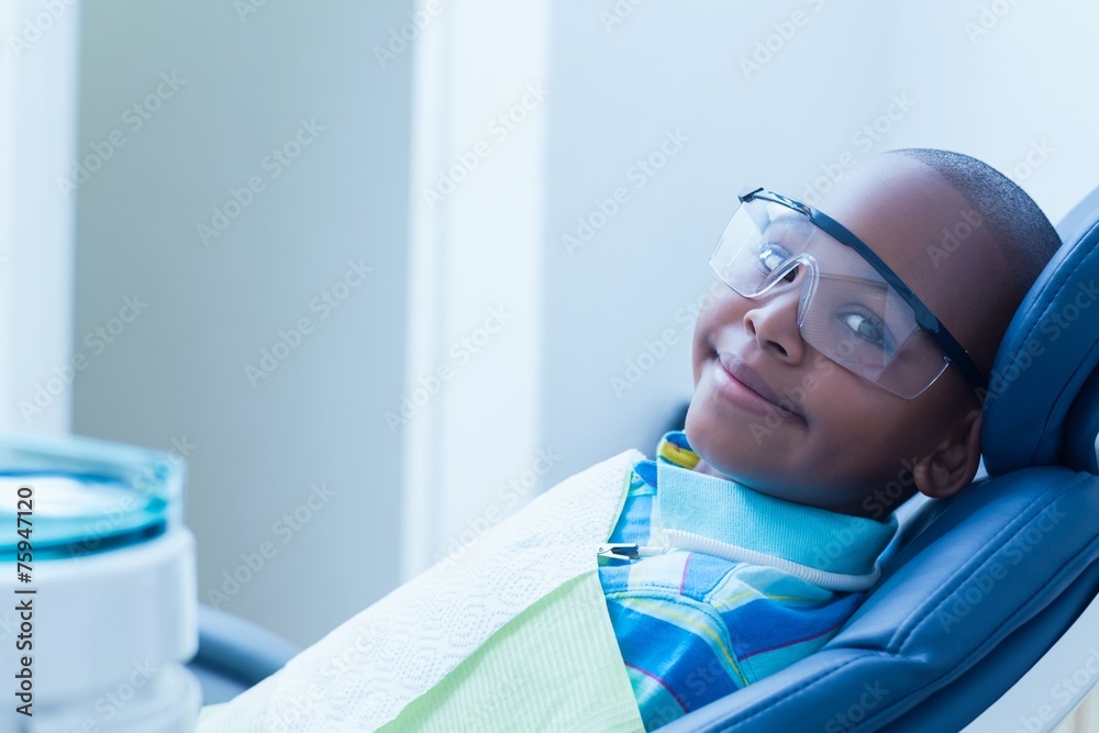 Smiling boy waiting for dental exam Smiling boy waiting for dental exam