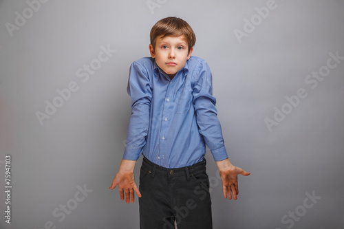 teenager boy in a shirt shrugs photo