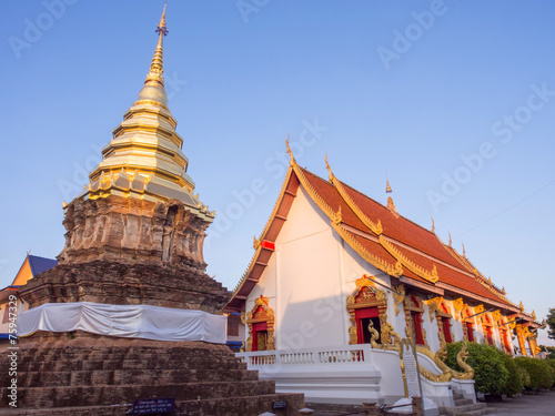 Golden pagoda behind main church in Thai temple
